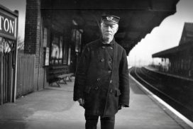 Rare photo of a Porter on the platform at Carshalton Railway Station in the 1920s enhanced by AI
